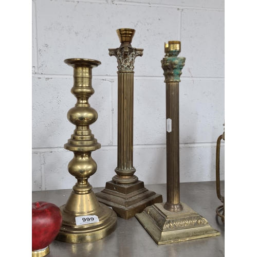 999 - Three vintage brass items including two column table lamps and a tall candle holder