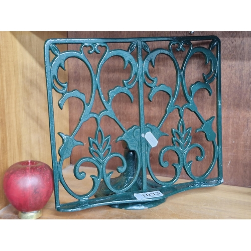 1033 - A cast metal cook book stand in a green painted finish.