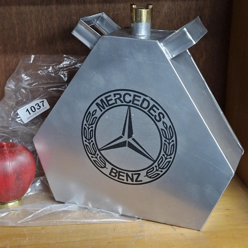 1037 - A silver toned Mercedes petrol cannister with brass screw top.