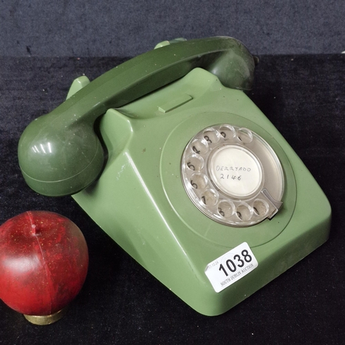 1038 - A vintage rotary dial telephone in two tones of khaki green.