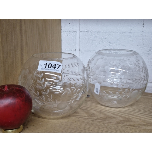 1047 - A pair of hand blow art etched glass candle holders featuring etched floral and foliate design with ... 