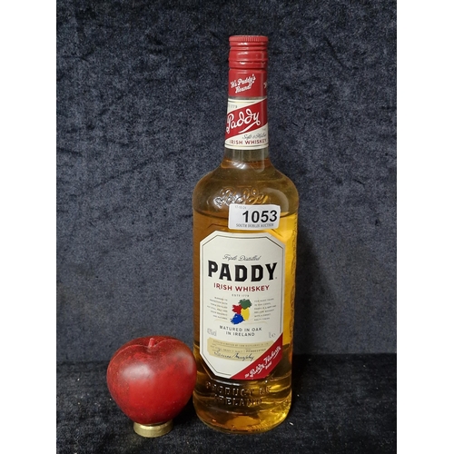 1053 - A 1 litre sealed bottle of triple distilled Paddy's Irish whiskey. RRP €33.99 via carryout.ie