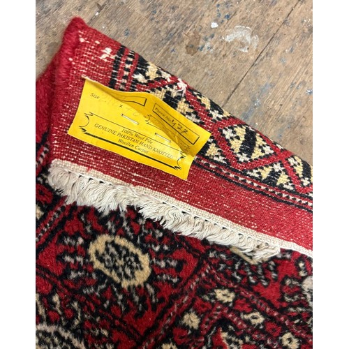 1219 - Star lot : A fabulous genuine Pakistan hand knotted 100% wool runner In red and and cream..298cm x 7... 