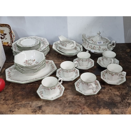 1097 - Johnson Brothers English dinnerware set features floral motifs. Includes plates, bowls, cups, saucer... 