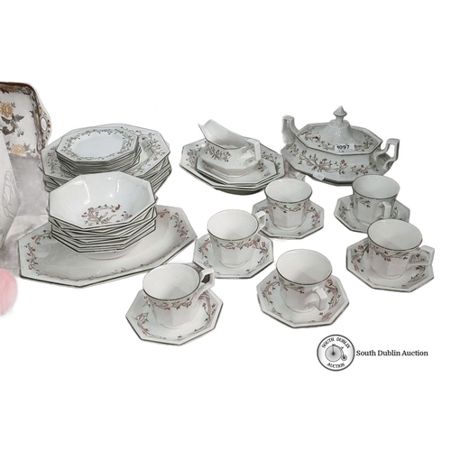 1097 - Johnson Brothers English dinnerware set features floral motifs. Includes plates, bowls, cups, saucer... 