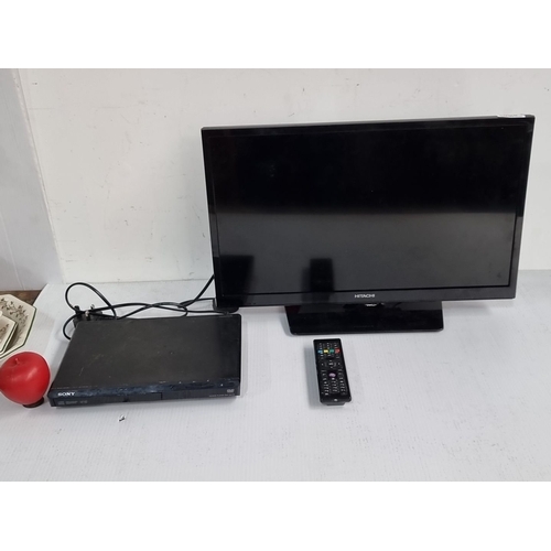 1098 - Hitachi 22HB21J06U 22-inch TV with HDMI, accompanied by a Sony DVD player and remote control.