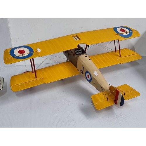 1099 - A large Vintage model biplane with yellow wings, replicating a World War I military aircraft. Featur... 