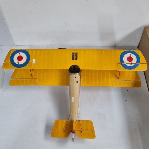 1099 - A large Vintage model biplane with yellow wings, replicating a World War I military aircraft. Featur... 