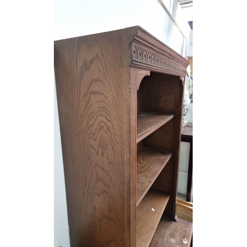 1105 - Antique oak bookcase with Gothic Revival details, three open shelves, and two lower cabinet doors. A... 