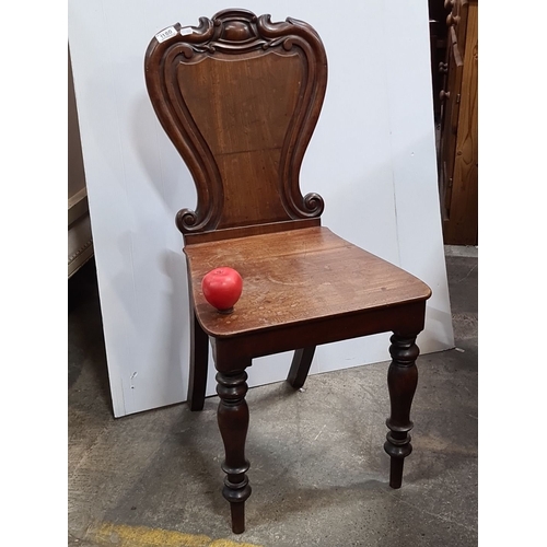 1180 - Victorian mahogany chair featuring carved scroll back and turned legs. Approximately 85cm high, 45cm... 