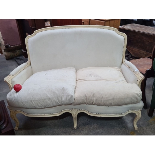 1187 - Antique French-style loveseat, upholstered in cream fabric with carved wooden frame and bergere back... 