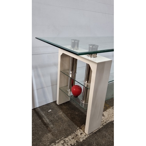 Glass console table with modern chrome accents and white supports