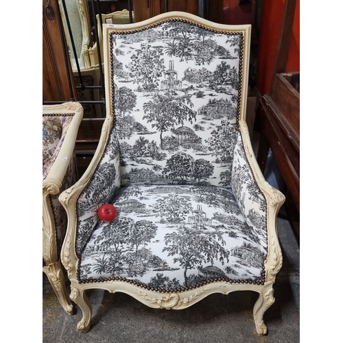 1266 - Star Lot : Ornate Louis XV-style armchair featuring toile de Jouy upholstery and carved wood frame. ... 