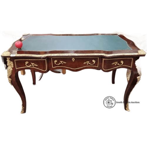 1267 - Star Lot : A French Mahogany desk with green leather inlay top, ornate gilt bronze ormolu mounts, an... 