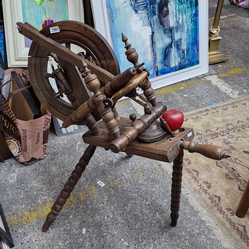 1061 - An antique example of a 19th century elm wood spinning wheel featuring lovely bobbin turned features... 