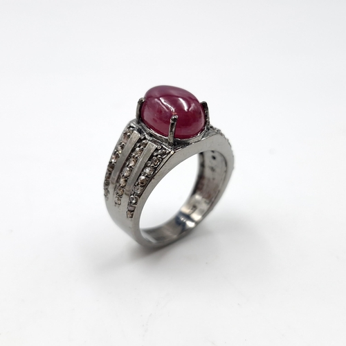 1280 - Star lot : A cabochon natural ruby stone ring with a three strand diamond mount set in sterling silv... 