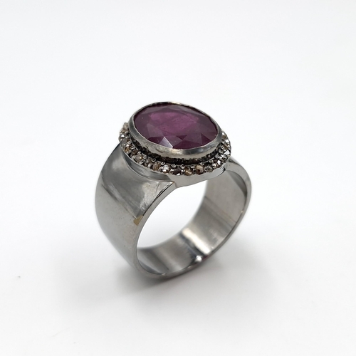 1281 - Star Lot : A fine example of a wide band facet cut natural ruby and diamond Ring mounted in sterling... 