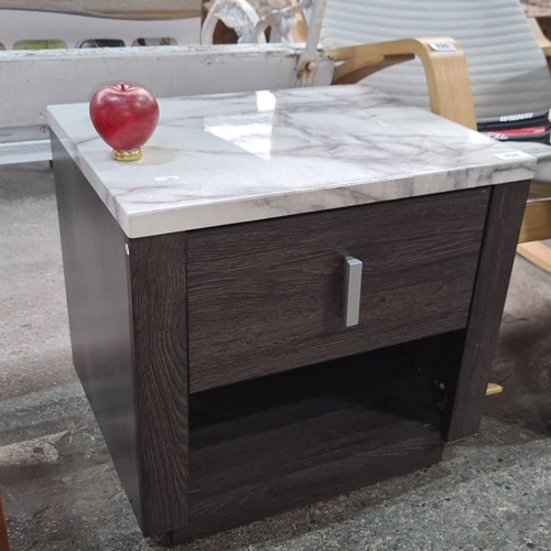 1284 - A stylish side table with a marble effect top and dark wood finish, featuring a single pull-out draw... 