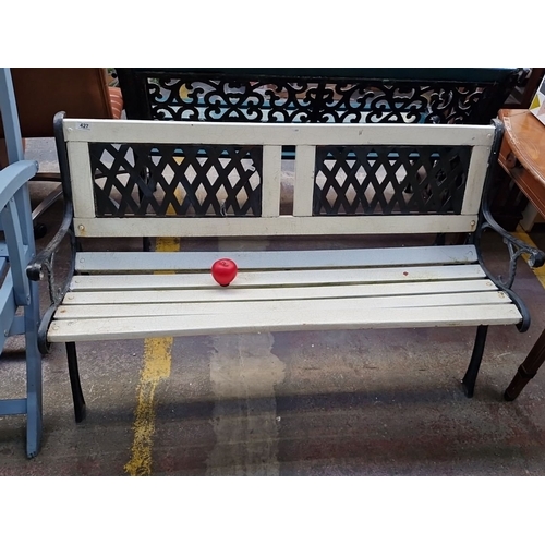 1295 - A very sweet cast iron garden bench featuring lattice backrest and wooden seat Dimensions: 123cm wid... 