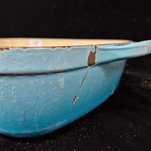 137 - A heavy cast iron double handled Le Creuset casserole dish, stamped to handles and base. (there is a... 