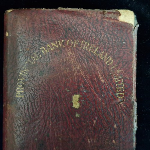 151 - An antique provincial Bank of Ireland limited moneybox in the form of a book. Stamped 'tailor law & ... 