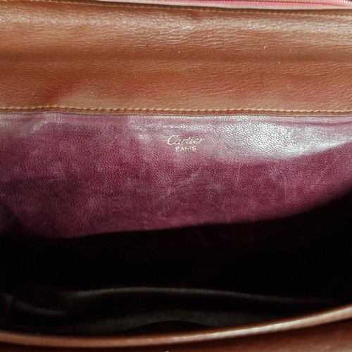 163 - Star Lot: An original vintage Cartier Paris Burgundy leather clutch bag with handwear. RRP: €280 on ... 