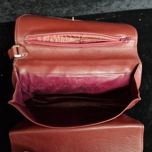 163 - Star Lot: An original vintage Cartier Paris Burgundy leather clutch bag with handwear. RRP: €280 on ... 