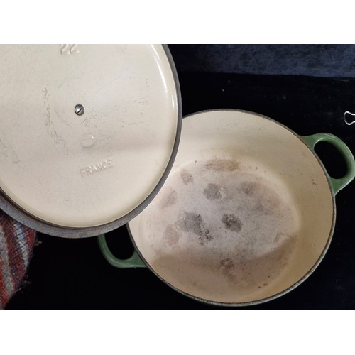 229 - Two heavy cast iron pieces of Le Creuset kitchenware including a lidded casserole dish and a double ... 