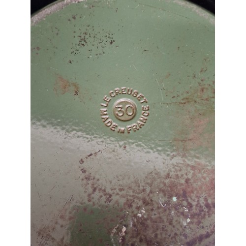 229 - Two heavy cast iron pieces of Le Creuset kitchenware including a lidded casserole dish and a double ... 