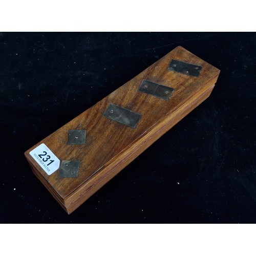 231 - A vintage dominos set housed in a camphor wood box which features brass toned decoration to top and ... 