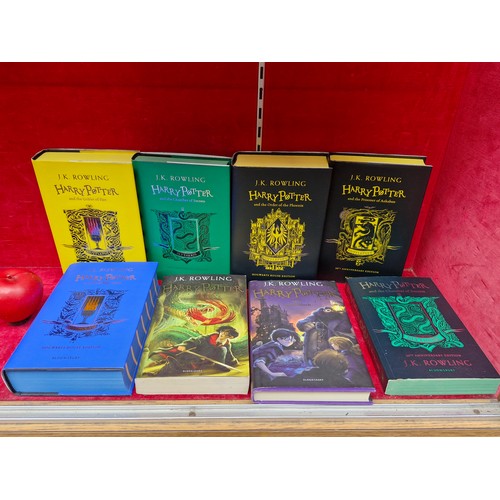 319 - A collection of eight Harry Potter books including five House Editions, two Chamber of Secrets and o... 