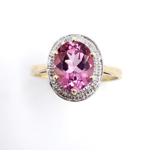 1 - Star Lot : A beautiful nine carat gold large pink spinal gemstone ring set with diamond surround. Si... 