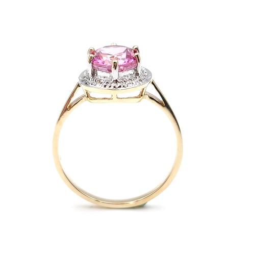 1 - Star Lot : A beautiful nine carat gold large pink spinal gemstone ring set with diamond surround. Si... 