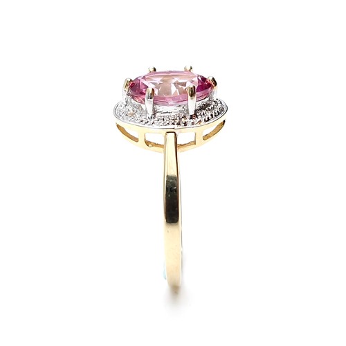 1 - Star Lot : A beautiful nine carat gold large pink spinal gemstone ring set with diamond surround. Si... 