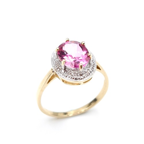 1 - Star Lot : A beautiful nine carat gold large pink spinal gemstone ring set with diamond surround. Si... 