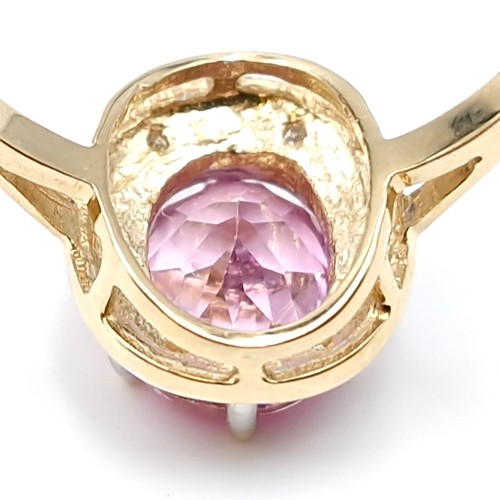 1 - Star Lot : A beautiful nine carat gold large pink spinal gemstone ring set with diamond surround. Si... 