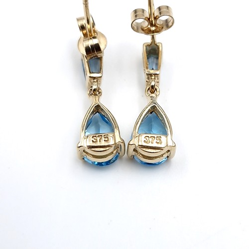 4 - Star lot : A lovely pair of nine carat gold stud earrings set with blue topaz gemstones. weight - 1.... 