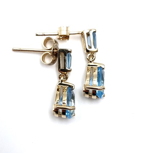 4 - Star lot : A lovely pair of nine carat gold stud earrings set with blue topaz gemstones. weight - 1.... 