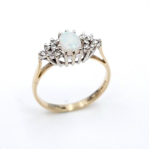 5 - Star lot : A lovely example of a nine carat gold opal gemstone set ring with diamond shoulders. Size... 