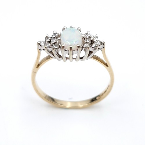 5 - Star lot : A lovely example of a nine carat gold opal gemstone set ring with diamond shoulders. Size... 