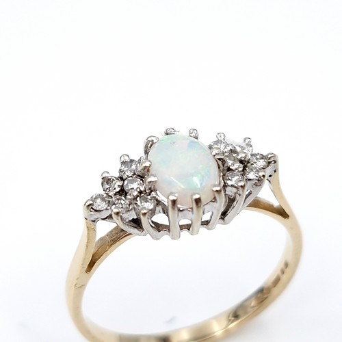 5 - Star lot : A lovely example of a nine carat gold opal gemstone set ring with diamond shoulders. Size... 