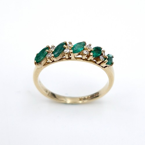 6 - Star lot : A five stone emerald ring set with diamonds. Ring size - M. Weight - 1.81 grams.