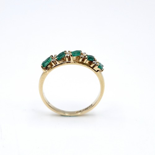 6 - Star lot : A five stone emerald ring set with diamonds. Ring size - M. Weight - 1.81 grams.