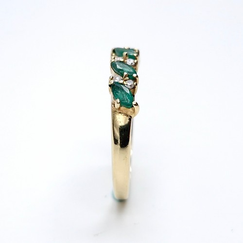 6 - Star lot : A five stone emerald ring set with diamonds. Ring size - M. Weight - 1.81 grams.