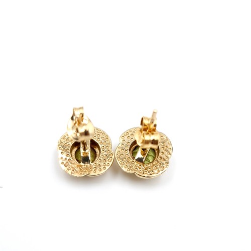 7 - A pair of peridot stud earrings set in nine carat gold. Weight - 2.08 grams.