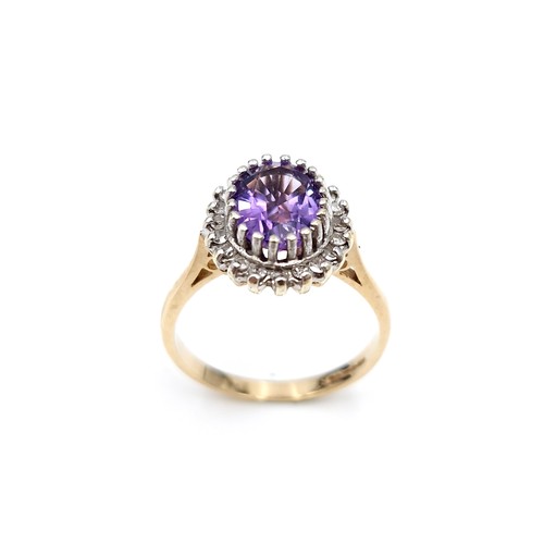 9 - Star lot : A lovely example of a nine carat gold amethyst gemstone ring set with diamond surround. S... 