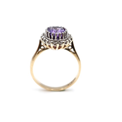 9 - Star lot : A lovely example of a nine carat gold amethyst gemstone ring set with diamond surround. S... 