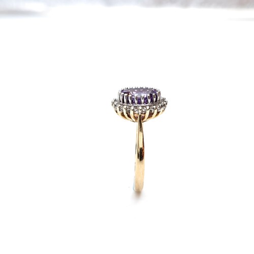 9 - Star lot : A lovely example of a nine carat gold amethyst gemstone ring set with diamond surround. S... 