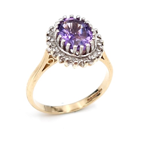 9 - Star lot : A lovely example of a nine carat gold amethyst gemstone ring set with diamond surround. S... 