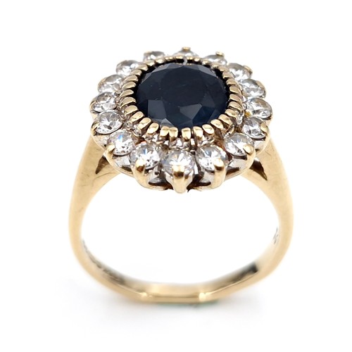 10 - Star lot : A stunning nine carat gold sapphire stone ring set with cubic zirconia surround. Ring siz... 